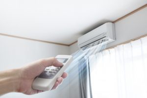 hand-holding-remote-to-ductless-air-handler