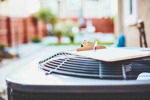 outside-air-conditioner-unit-with-clipboard-on-top