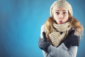 woman-looking-cold-imposed-on-blue-background