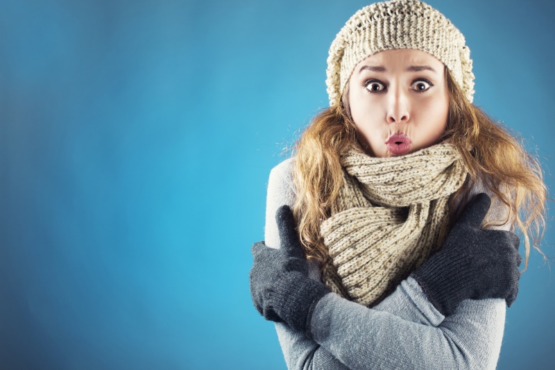 woman-looking-cold-imposed-on-blue-background