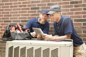 two-techs-working-on-ac-unit