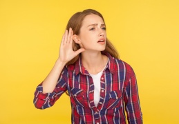 woman-holding-hand-to-ear-to-listen