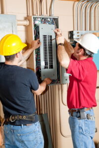 two-electricians-working-on-panel