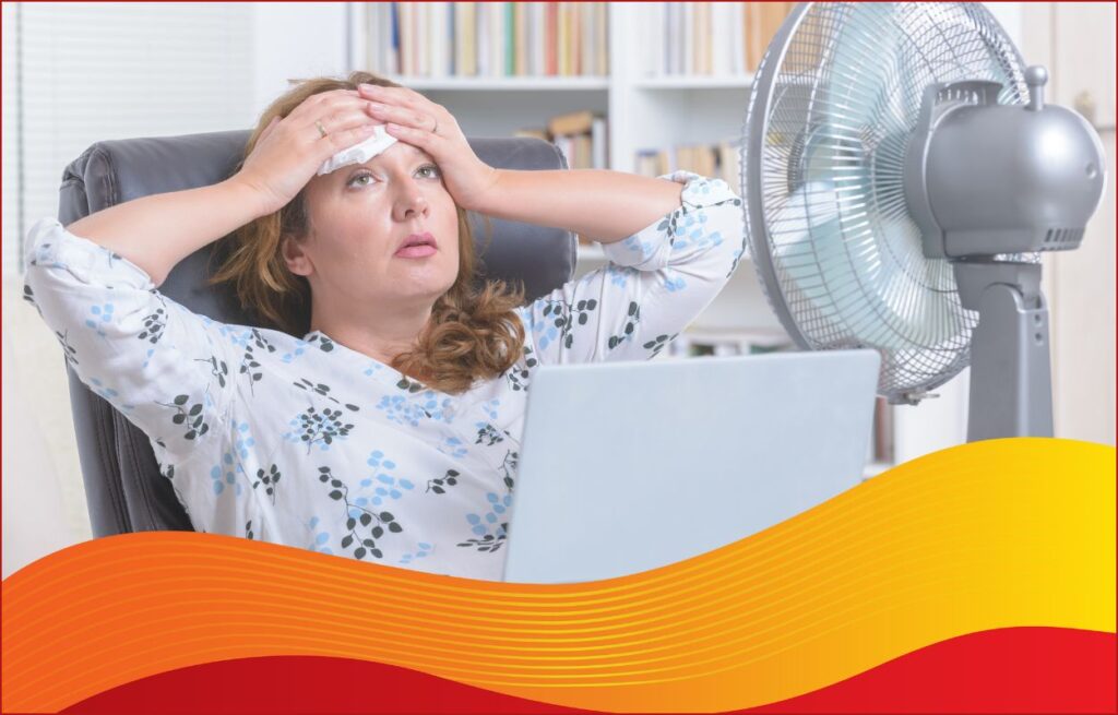 A women sweating at home because of a malfunctioning air conditioner.