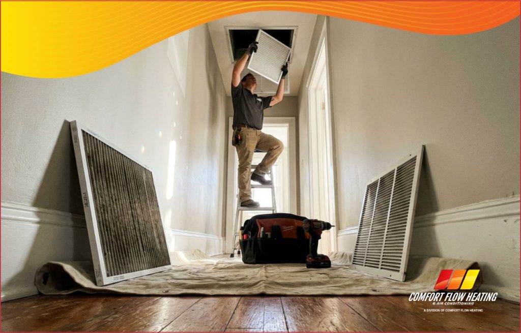 An HVAC tech changing an air filter.