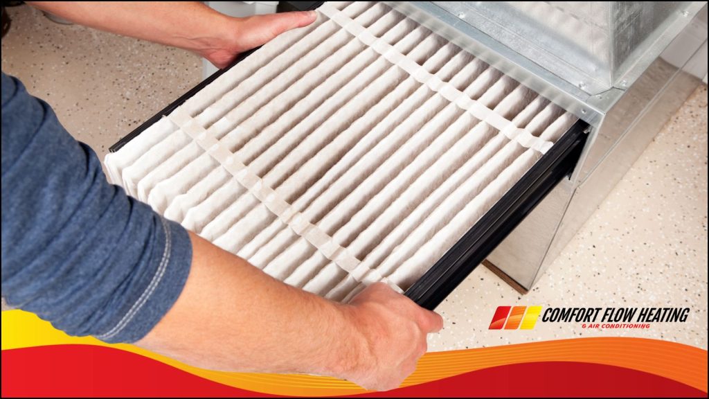 A comfort, flow HVAC technician changing Home air filter